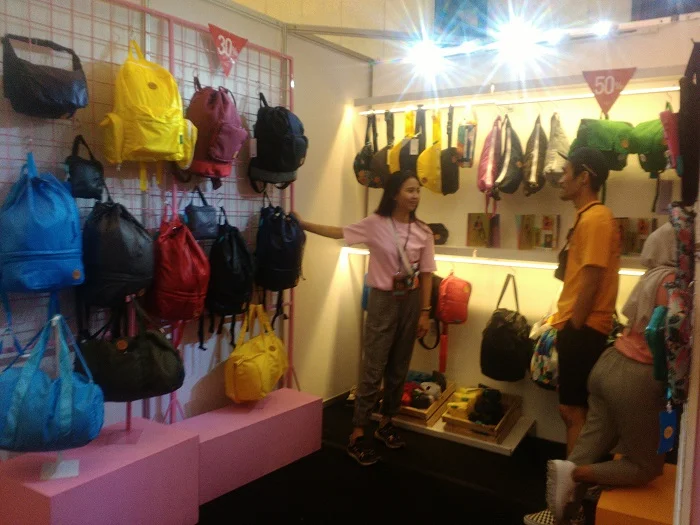 Colorful NIION bags hanging in a promotional booth