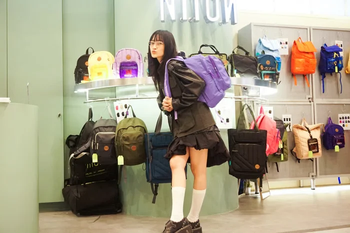 Shopper trying on a purple NIION backpack in a store
